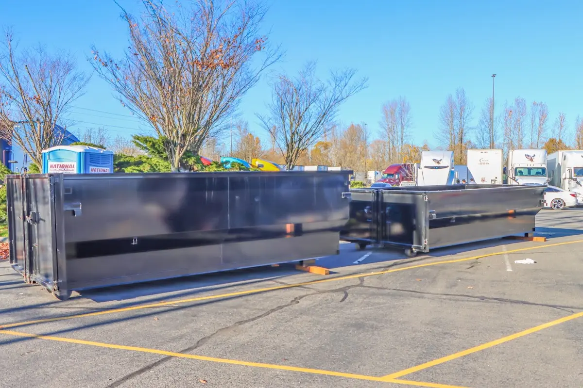 Professional dumpster rental service with roll-off container on residential driveway in Rockingham